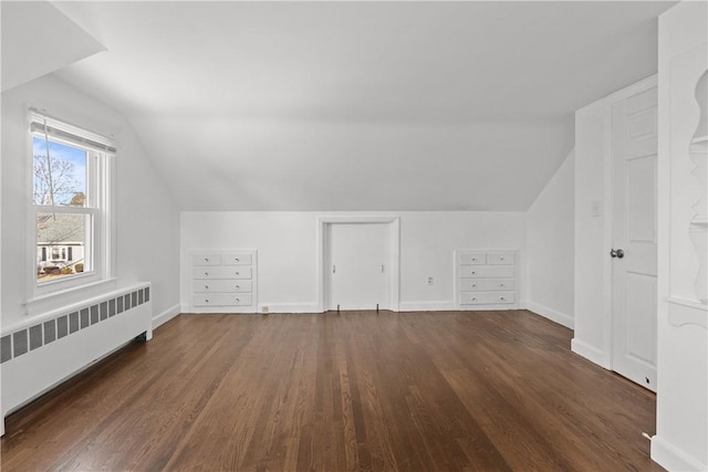 bonus room featuring radiator, baseboards, lofted ceiling, and wood finished floors