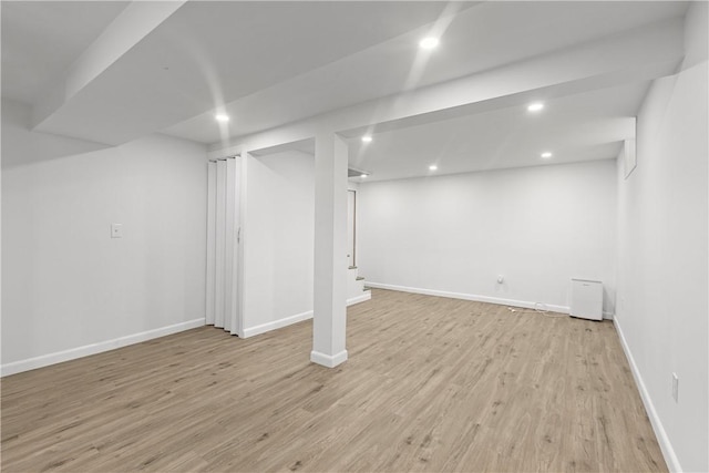 finished basement with recessed lighting, light wood-style flooring, and baseboards