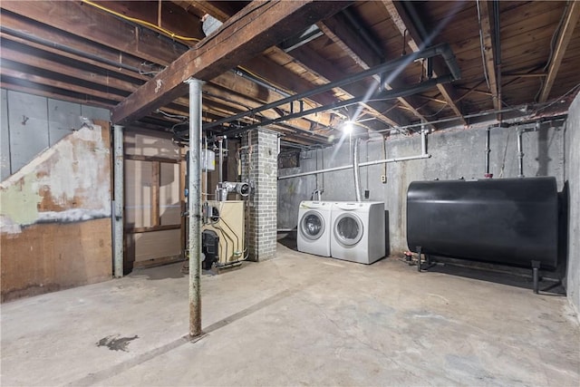 unfinished basement featuring heating fuel and independent washer and dryer