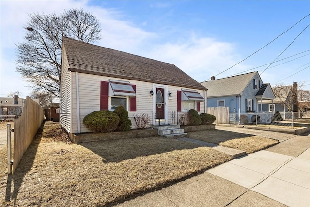 view of front of house with fence and roof with shingles