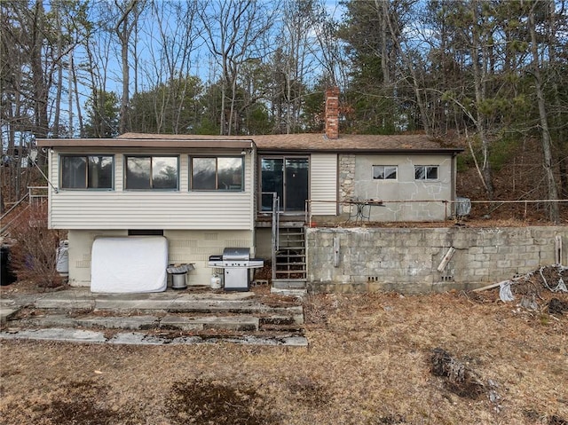 view of front of home featuring an attached garage and a chimney