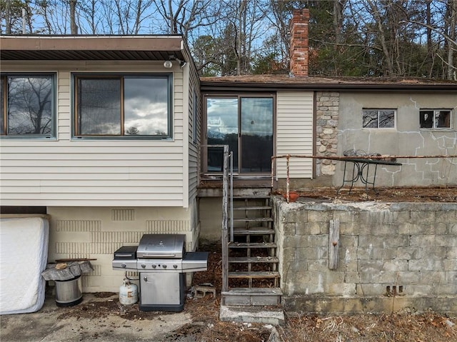 rear view of property featuring crawl space and a chimney