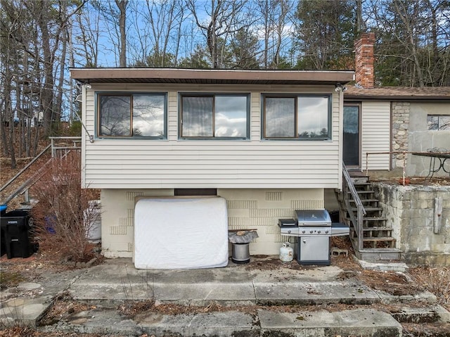 view of front of property with stairway and a chimney