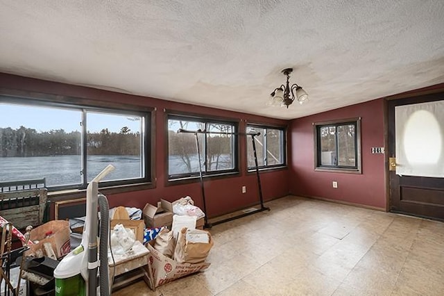 sunroom / solarium with vaulted ceiling and a chandelier