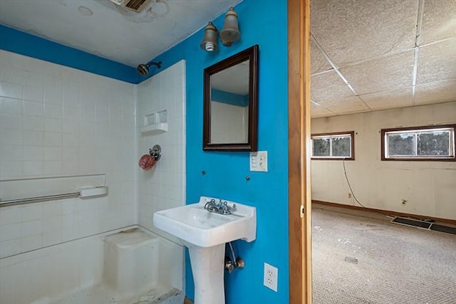 bathroom featuring a sink and walk in shower