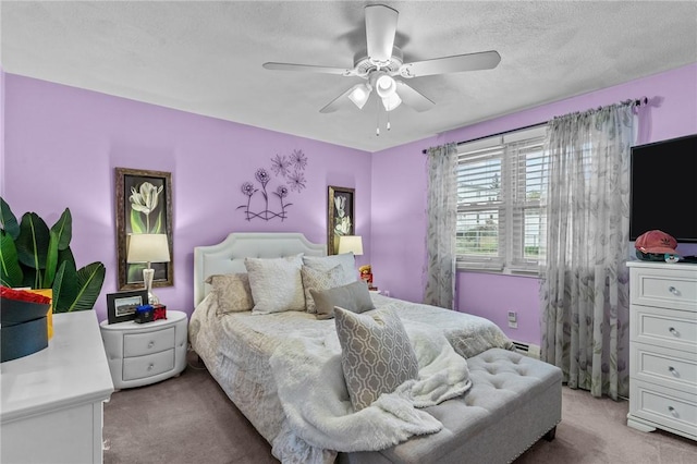 bedroom featuring a baseboard heating unit, a textured ceiling, carpet, and ceiling fan