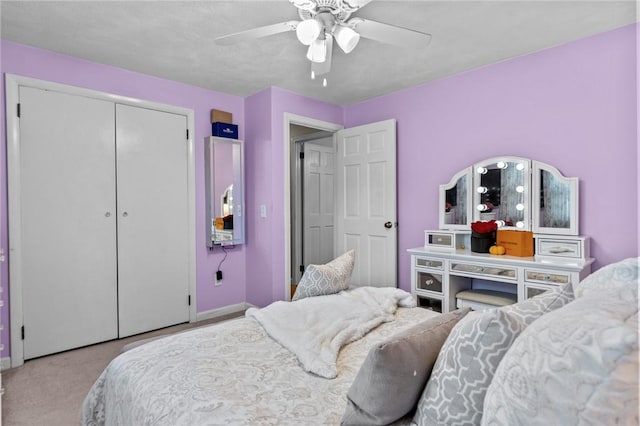 carpeted bedroom featuring a closet and a ceiling fan