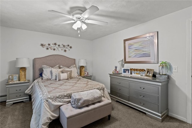 bedroom with dark carpet, a ceiling fan, a baseboard heating unit, and baseboards