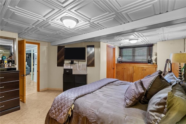 bedroom with baseboards and an ornate ceiling