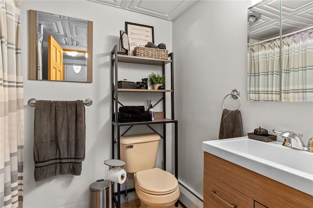 bathroom with vanity, toilet, and a baseboard radiator