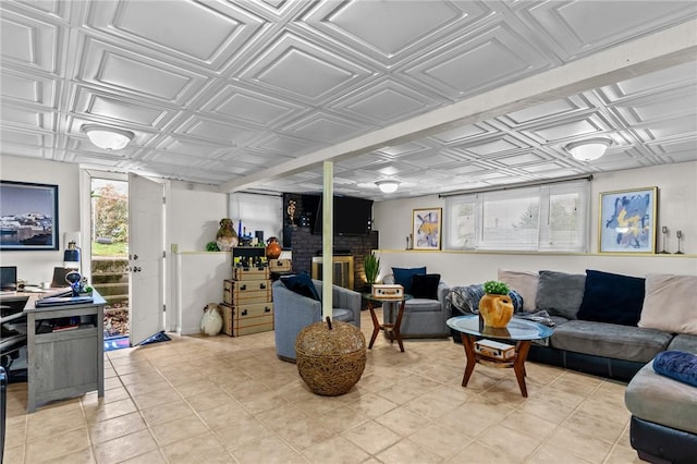 living room with light tile patterned floors, an ornate ceiling, and a fireplace