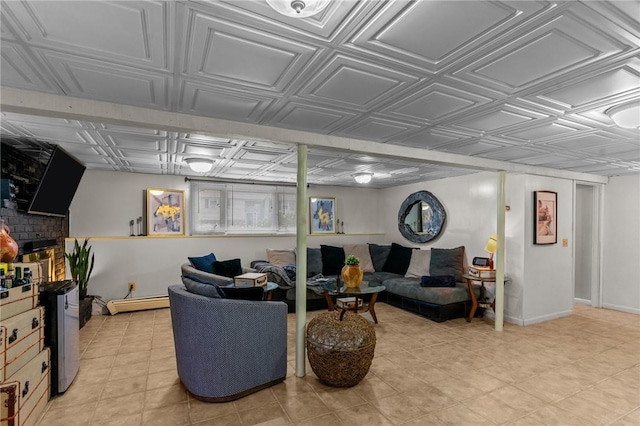 living area with baseboard heating, an ornate ceiling, and baseboards