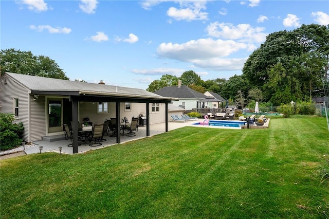 view of yard featuring an outdoor pool, a patio area, and fence