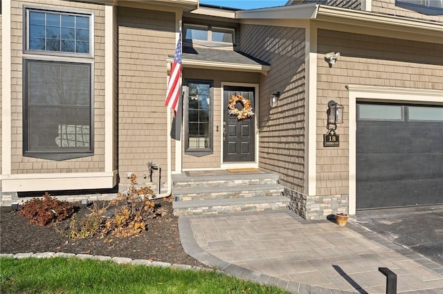 property entrance featuring an attached garage