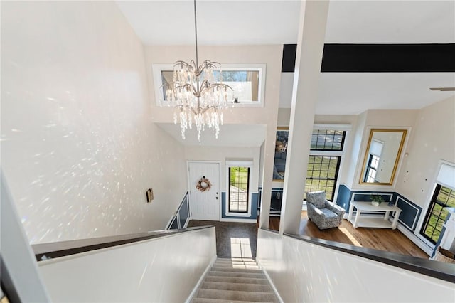 interior space featuring a chandelier and a towering ceiling