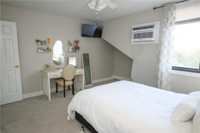 carpeted bedroom featuring a baseboard heating unit, baseboards, and a wall mounted air conditioner