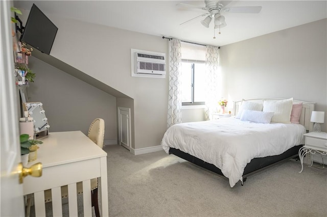 bedroom featuring light colored carpet, a wall mounted AC, and baseboards