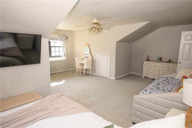 bedroom featuring vaulted ceiling, baseboards, carpet floors, and ceiling fan