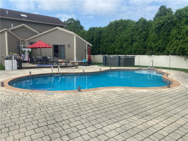 view of pool with a patio area, a fenced in pool, and fence