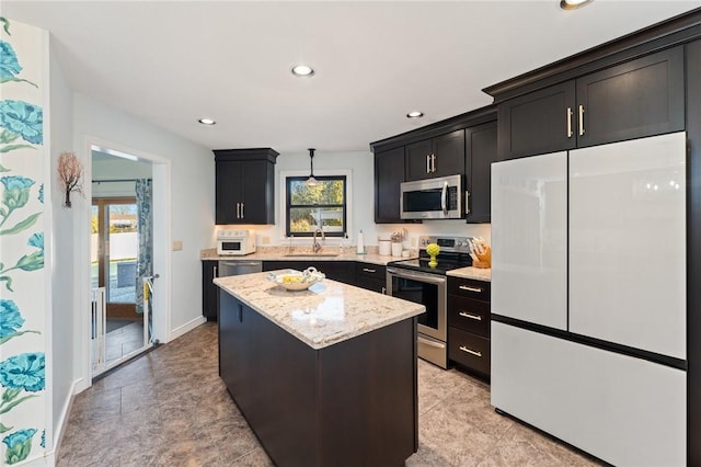 kitchen featuring a sink, a center island, plenty of natural light, and stainless steel appliances