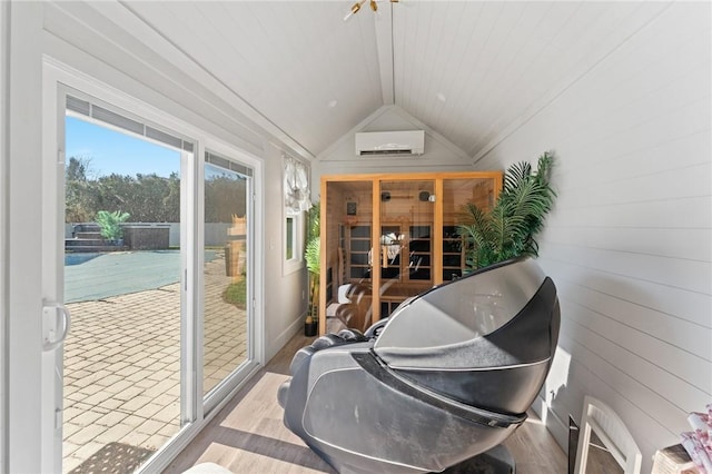 sunroom with an AC wall unit and vaulted ceiling