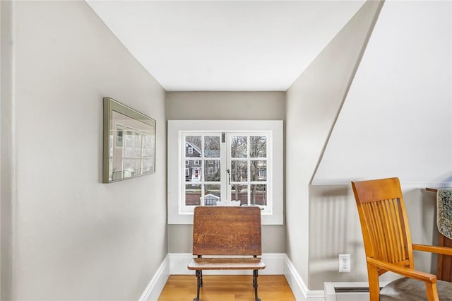 sitting room with baseboards and wood finished floors