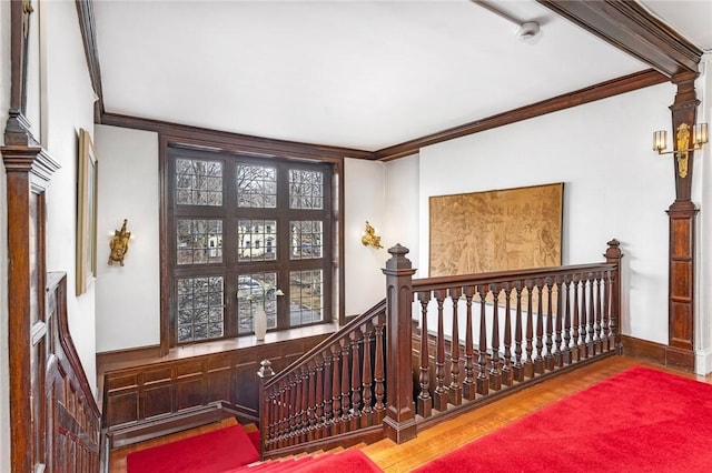 stairs featuring baseboards, wood finished floors, and ornamental molding