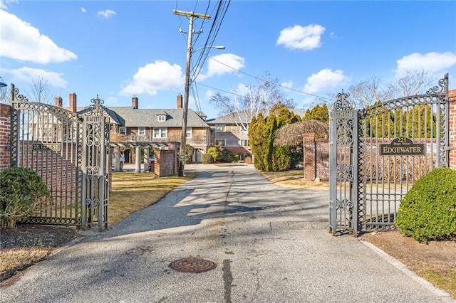 view of street featuring street lights and a gate