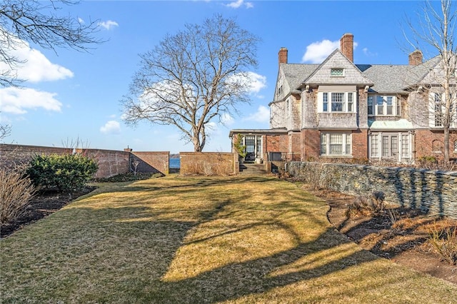 view of yard featuring fence and french doors
