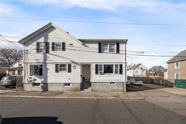 view of front of home featuring entry steps and fence