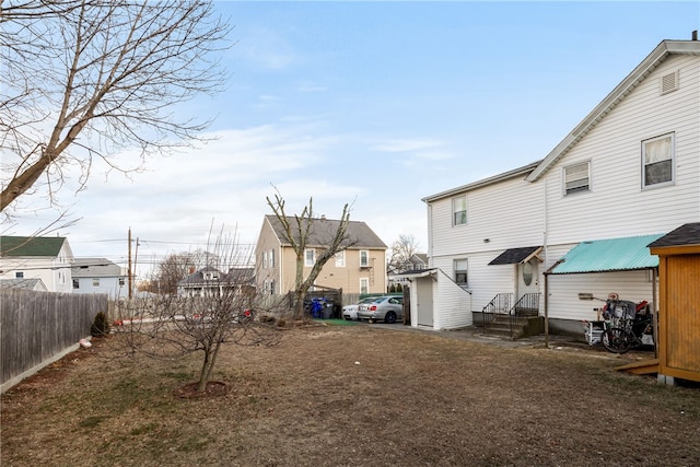 view of yard featuring a residential view and fence