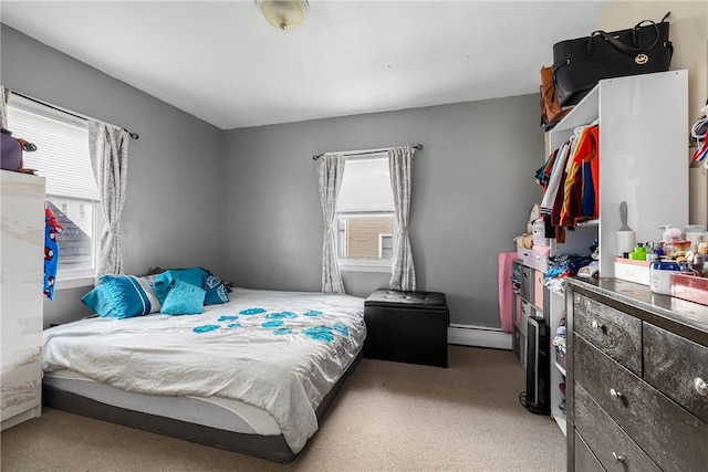 carpeted bedroom featuring baseboard heating