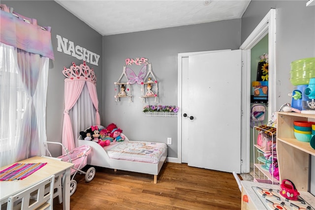 bedroom with wood finished floors