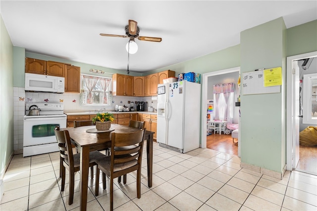 kitchen with white appliances, light tile patterned flooring, light countertops, decorative backsplash, and ceiling fan