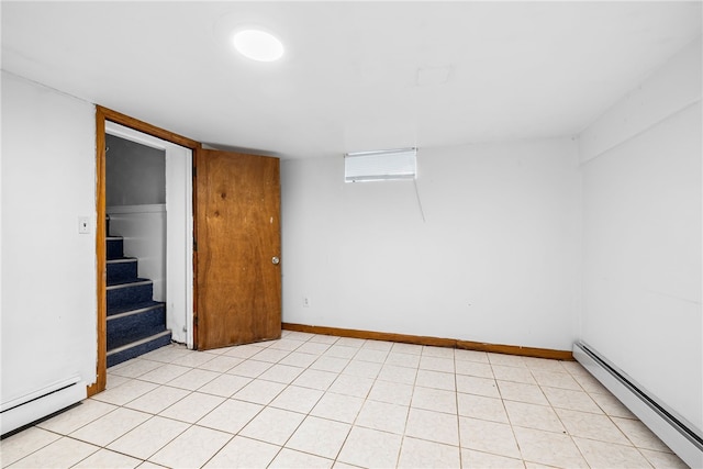 finished basement featuring stairway, baseboards, and a baseboard radiator