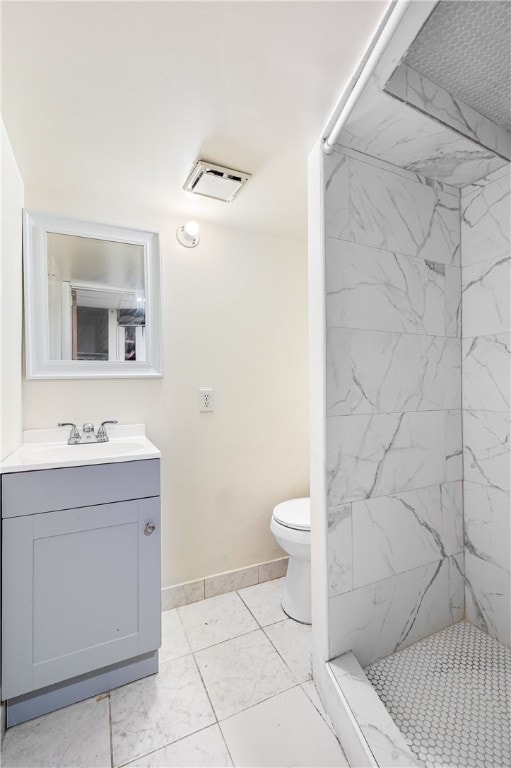 bathroom with visible vents, baseboards, toilet, a stall shower, and vanity