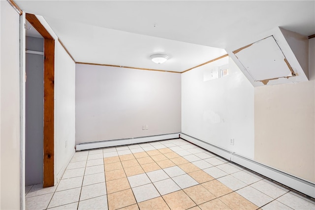 empty room with light tile patterned flooring, a baseboard heating unit, and ornamental molding