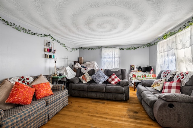 living room with a textured ceiling and wood finished floors