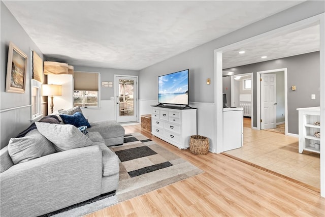 living room featuring baseboards and light wood-style floors