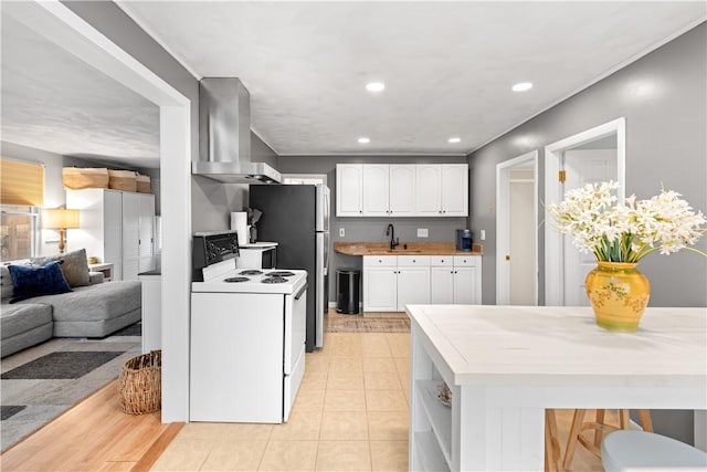 kitchen with white range with electric cooktop, a sink, recessed lighting, white cabinets, and extractor fan