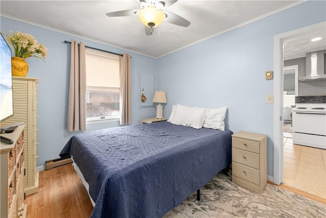 bedroom with a baseboard heating unit, wood finished floors, and crown molding