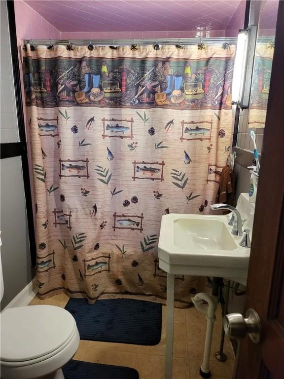 141 Centennial St, Burrillville, RI 02859 - bathroom featuring toilet, a shower with shower curtain, tile patterned flooring, vaulted ceiling, and a sink