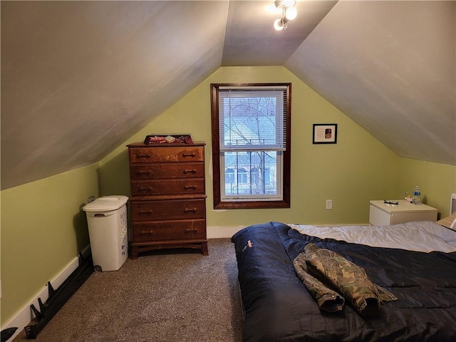 carpeted bedroom with lofted ceiling and baseboards