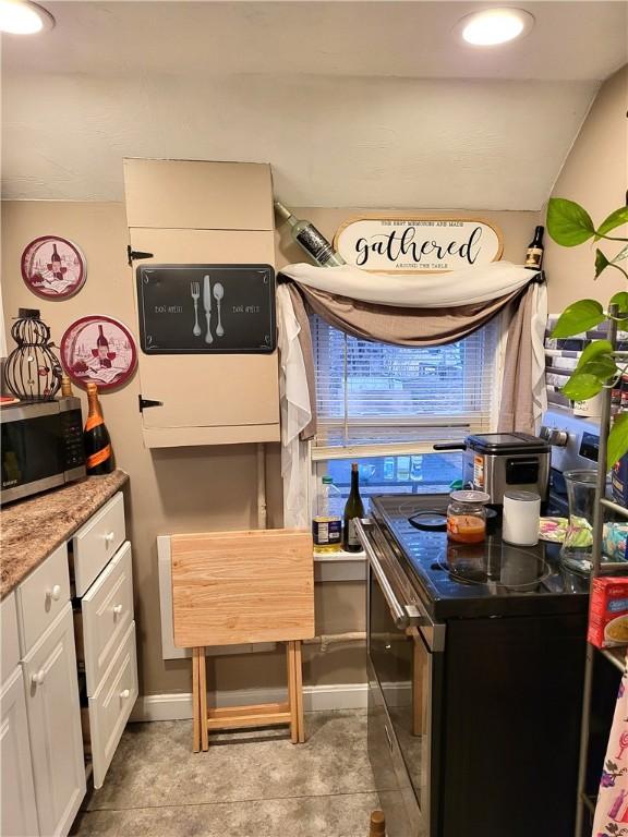 141 Centennial St, Burrillville, RI 02859 - kitchen with stainless steel microwave, white cabinetry, and baseboards