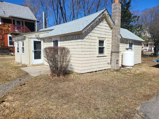 141 Centennial St, Burrillville, RI 02859 - view of home's exterior featuring a chimney, a shingled roof, and a balcony
