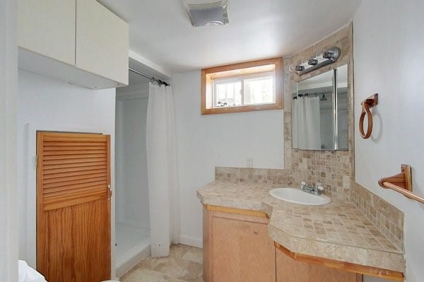 full bath featuring backsplash, vanity, and a shower with shower curtain