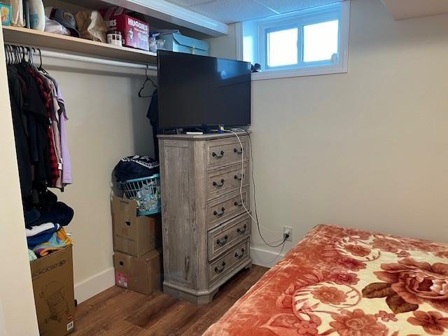 bedroom with wood finished floors and baseboards