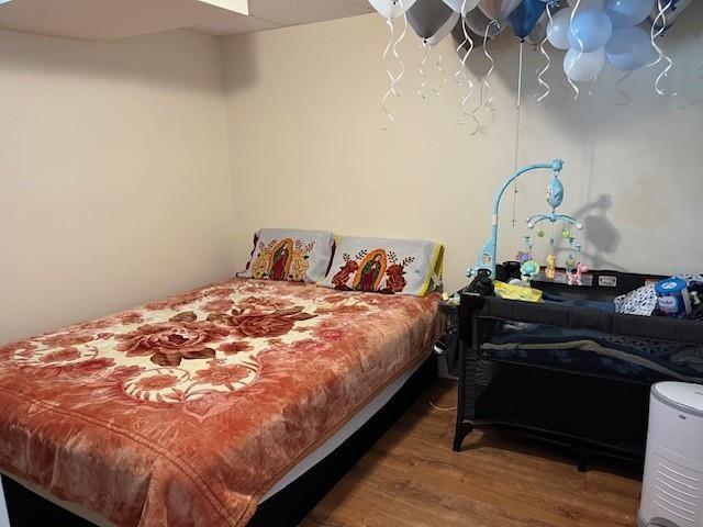 bedroom featuring wood finished floors