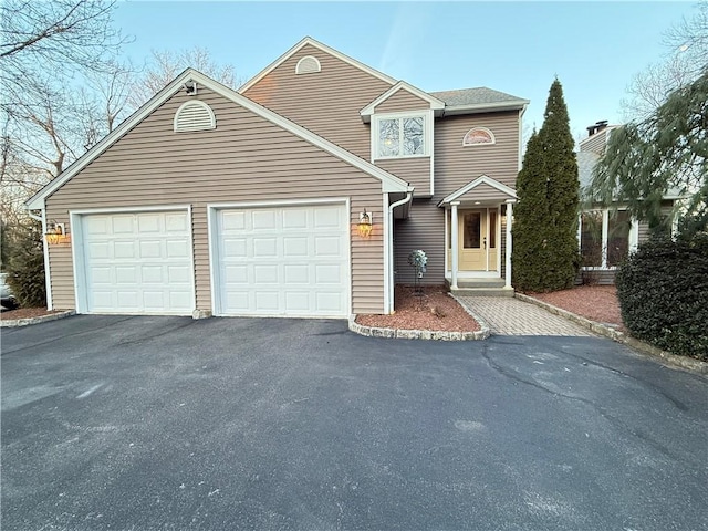 traditional-style home featuring driveway and a garage