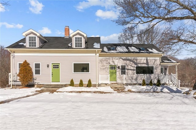 view of front of property featuring covered porch and a chimney